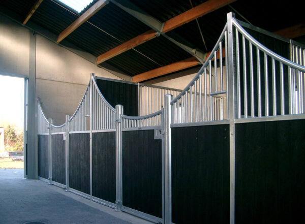 plastic stable panels with curved steel frames showing paved flooring and hinged gates