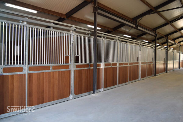 timber and steel stable panels with sliding gates and cement floor