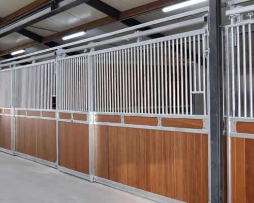 timber and steel stable panels with sliding gates and cement floor